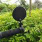 Bicycle rearview convex mirror attached to handlebar with black mounting arm.