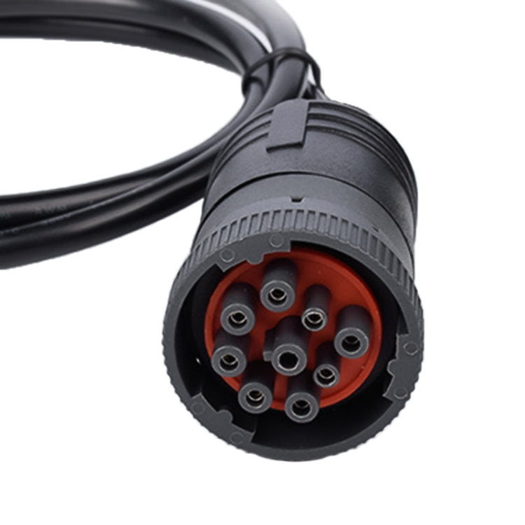 Close-up of 9-pin diagnostic interface connector with orange ring and metal pins