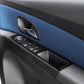 Close-up of carbon fiber-look window switch panel sticker with switch cutouts