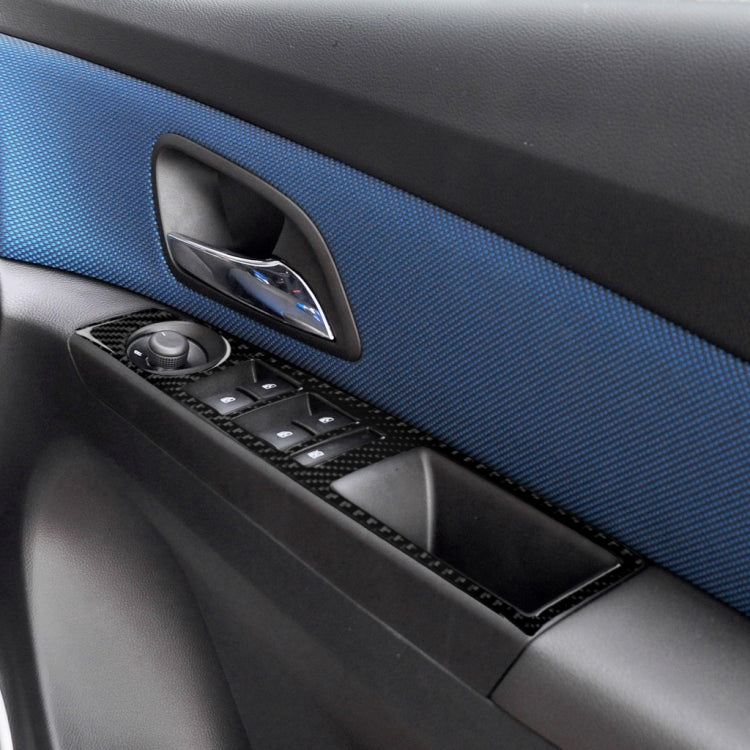 Close-up of carbon fiber-look window switch panel sticker with switch cutouts