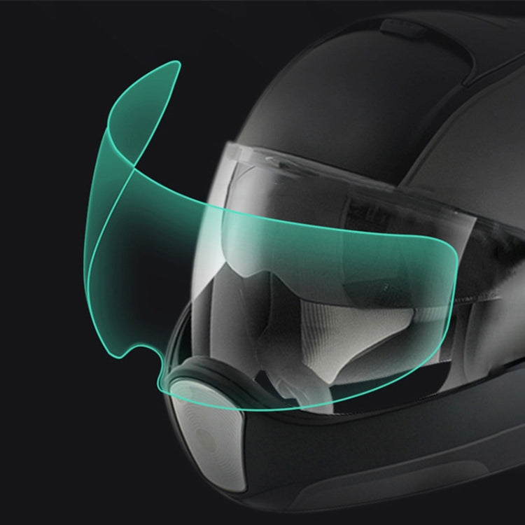 Motorcycle helmet visor anti-fog film applied, clear curved shield with green tint effect