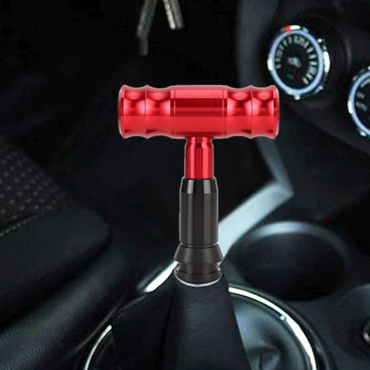 Red automatic gear shift knob with ribbed grip and metal T-base