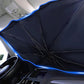 Black windshield sunshade with blue trim and umbrella spokes