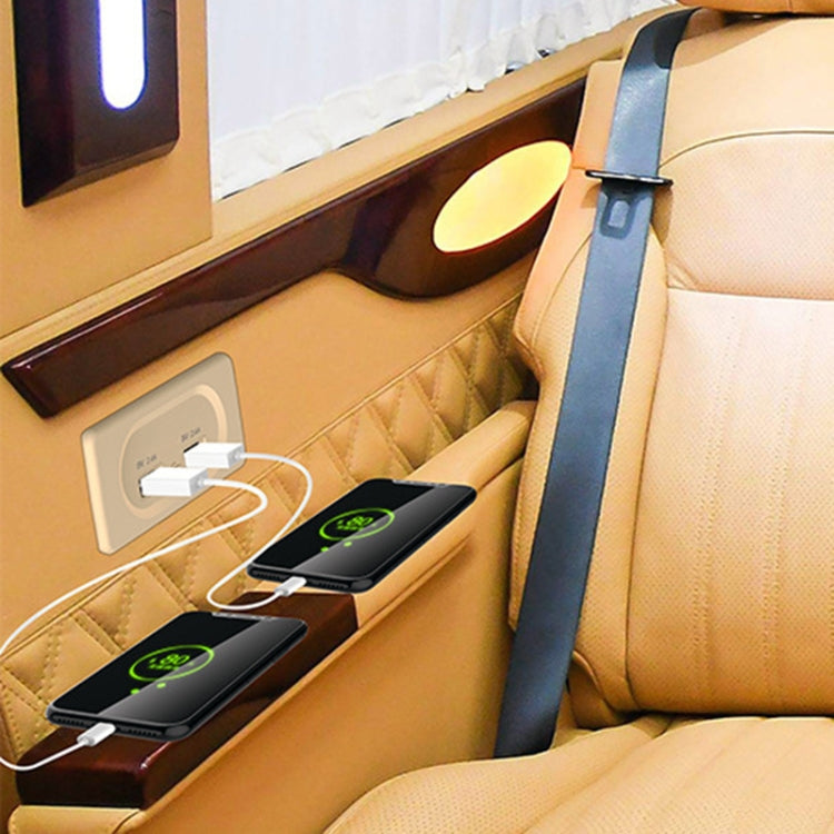 Dual-USB car charger plugged into RV seat panel with two connected USB devices