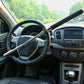 Car steering wheel lock secured across the steering wheel with black telescopic handle