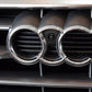 Installed front camera centered in grille opening with chrome surround on car