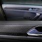 Carbon fiber door panel trim fitted near handle, dark woven finish