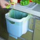 Blue wall-mounted folding trash can with white rim and plastic liner