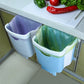 Blue wall-mounted folding trash can with white rim and green plastic liner