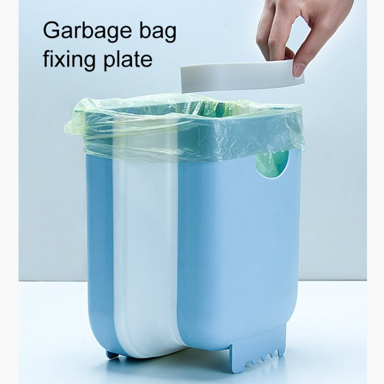 Blue wall-mounted folding trash can holding a lined garbage bag