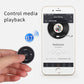 Bluetooth steering-wheel remote controller with media play controls held near a phone