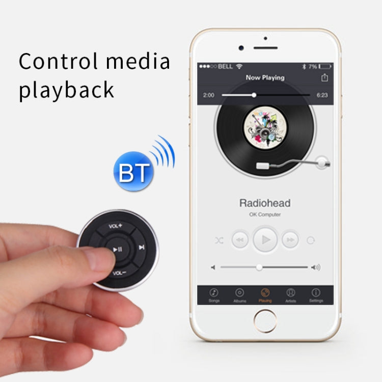Bluetooth steering-wheel remote controller with media play controls held near a phone