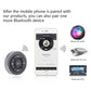 Round Bluetooth car remote controller with play/pause and volume buttons beside phone