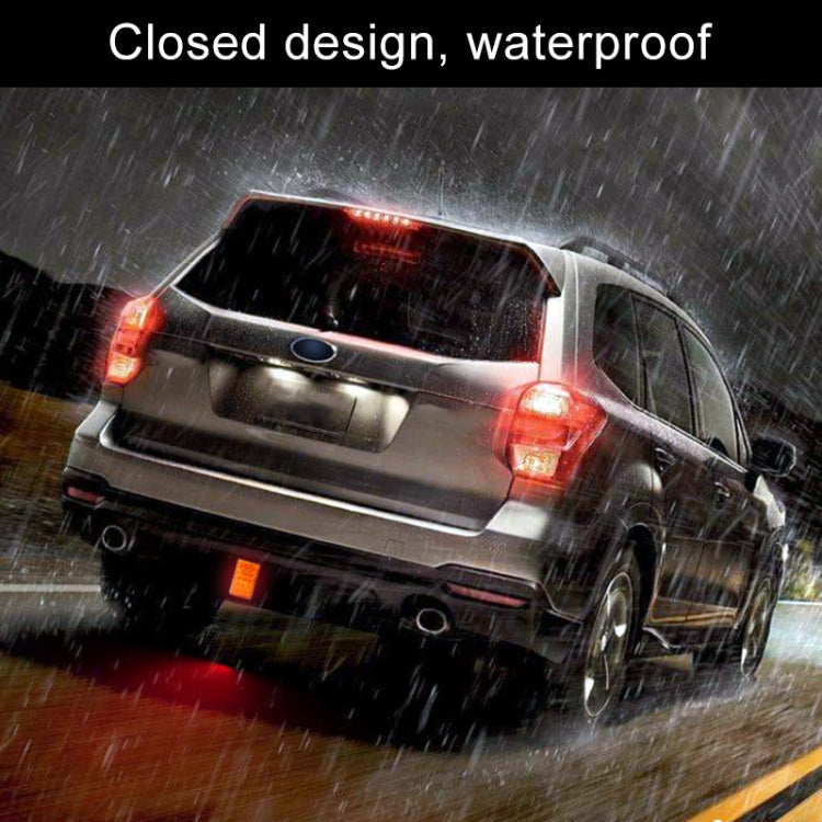 Square LED car light with red illumination on rear in wet weather