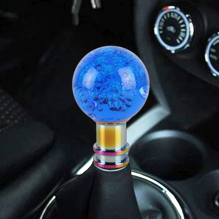 Blue acrylic gear shift knob with bubble-like texture and rainbow metal stem.