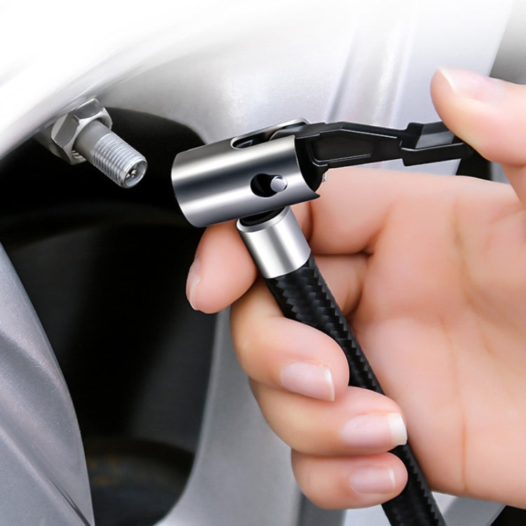 Hand using a tire valve connector with the portable air pump