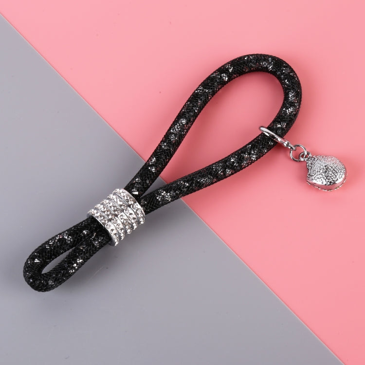 Black glitter car keychain close-up with rhinestone centerpiece and teardrop charm