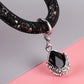 Black car keychain detail: silver clasp and black teardrop gem charm