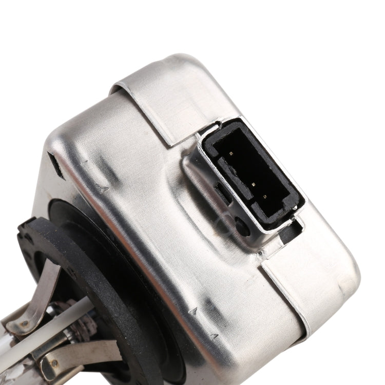 Close-up of silver HID xenon bulb housing with black socket and blue-tinted glass tube