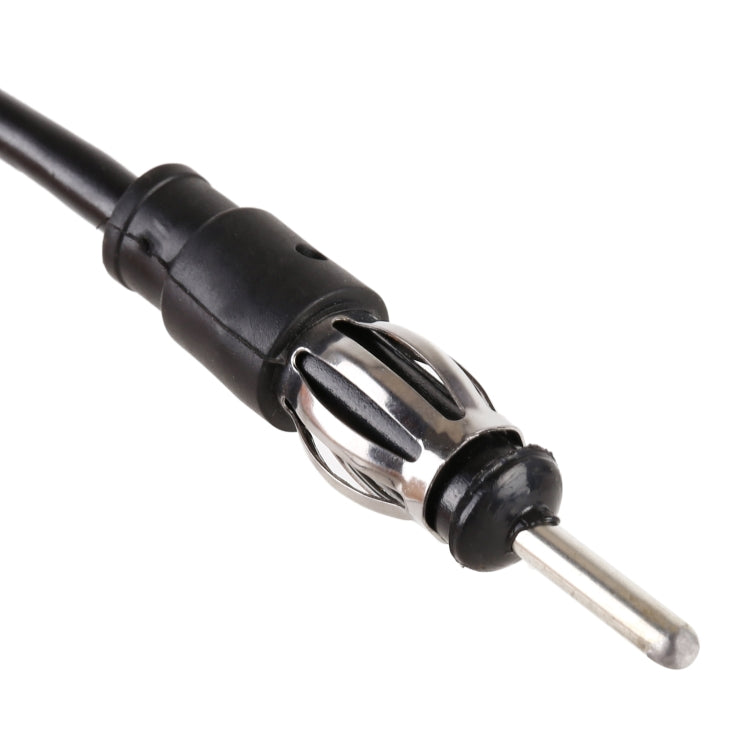 FM antenna cable connector with metal pin and black housing, close-up