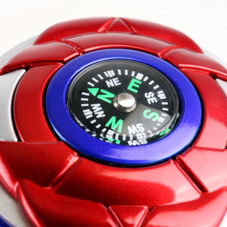 Close-up of red steering wheel spinner compass dial with blue ring and markers