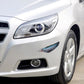 Feather car sticker near front bumper and headlight on a white car