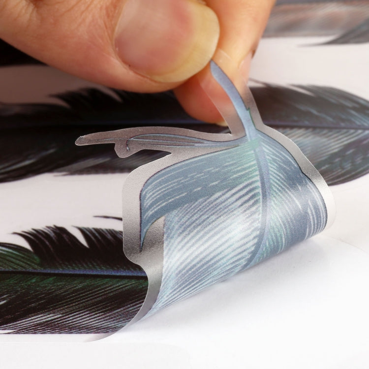 Feather car sticker close-up being peeled, blue and silver feather pattern