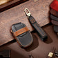 Black leather key cover with Hallmo tag, key ring, and stitched long strap for key fob