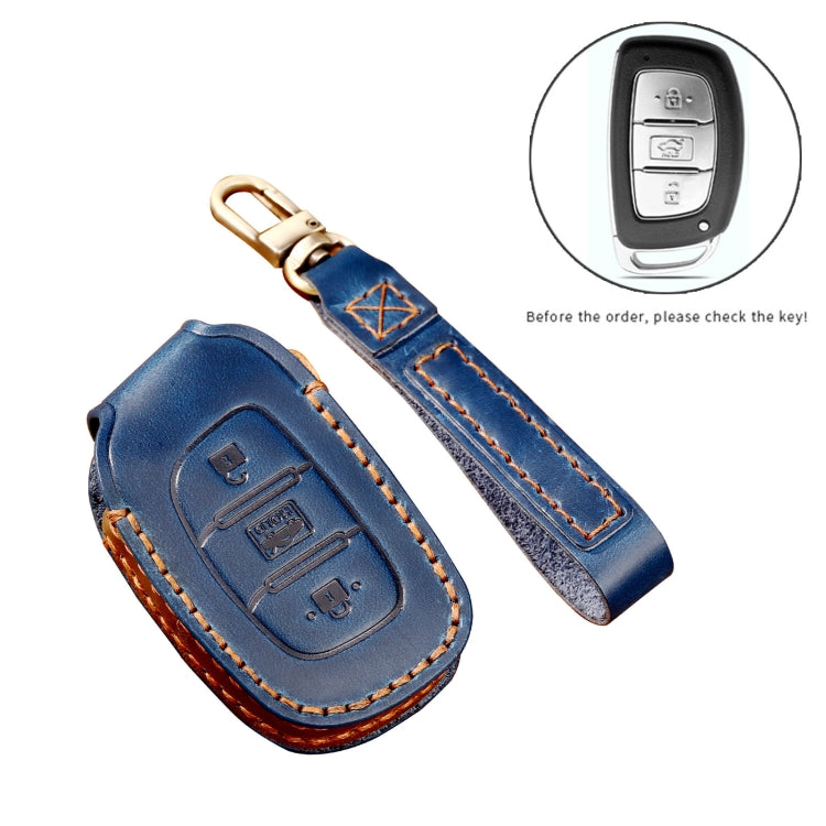Blue leather key fob cover and key strap with brass key ring, remote icon inset