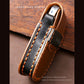 Black leather key cover strap close-up with double stitching, brass loop, and leather edge