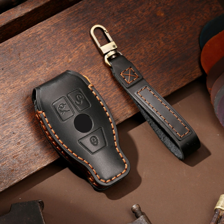 Black cowhide leather key fob strap cover with keyring, button icons, orange stitching