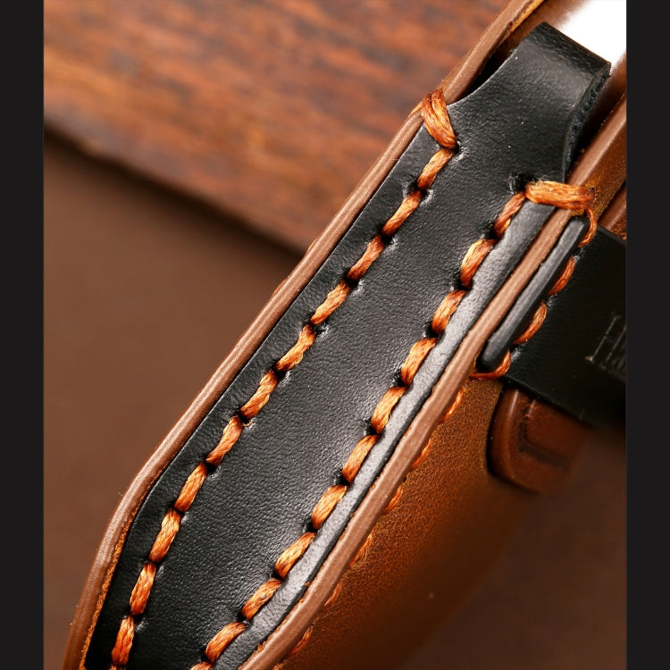 Close-up of black leather key cover strap with orange stitched seam and metal clip