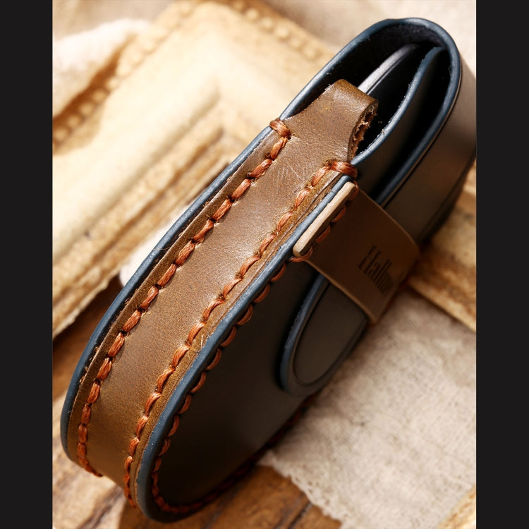 Tan and brown leather key fob case close-up with edge stitching.
