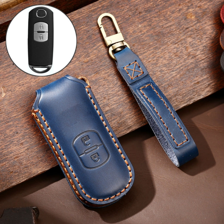 Blue leather key protective cover with button cutout, key ring, and orange edge stitching