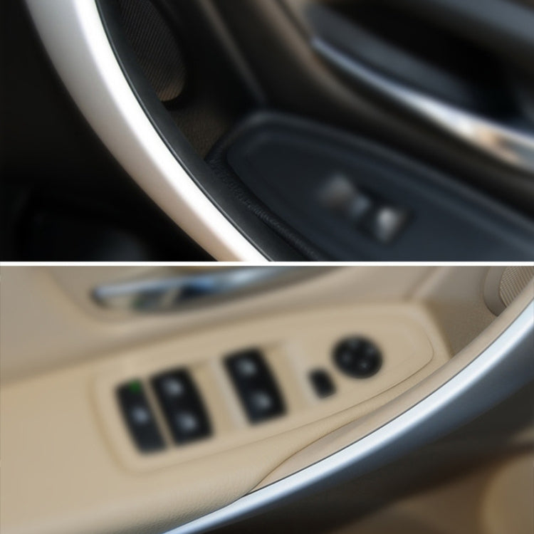 Beige inner armrest door handle area with window control switches close-up