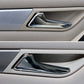 Chrome interior door pull handle trim on door panel with black insert