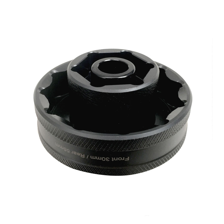 Black wheel nut socket tool with textured grip and central drive opening