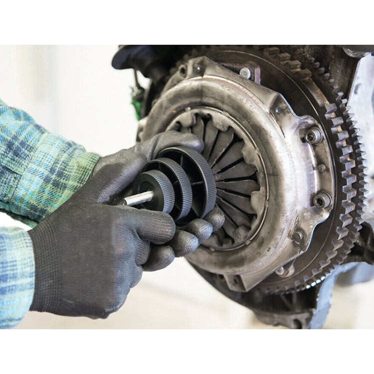 Clutch assembly alignment using black centering tool held by gloved hands