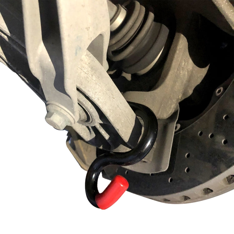 U-shaped pry bar tool positioned near suspension under the wheel well, red grip