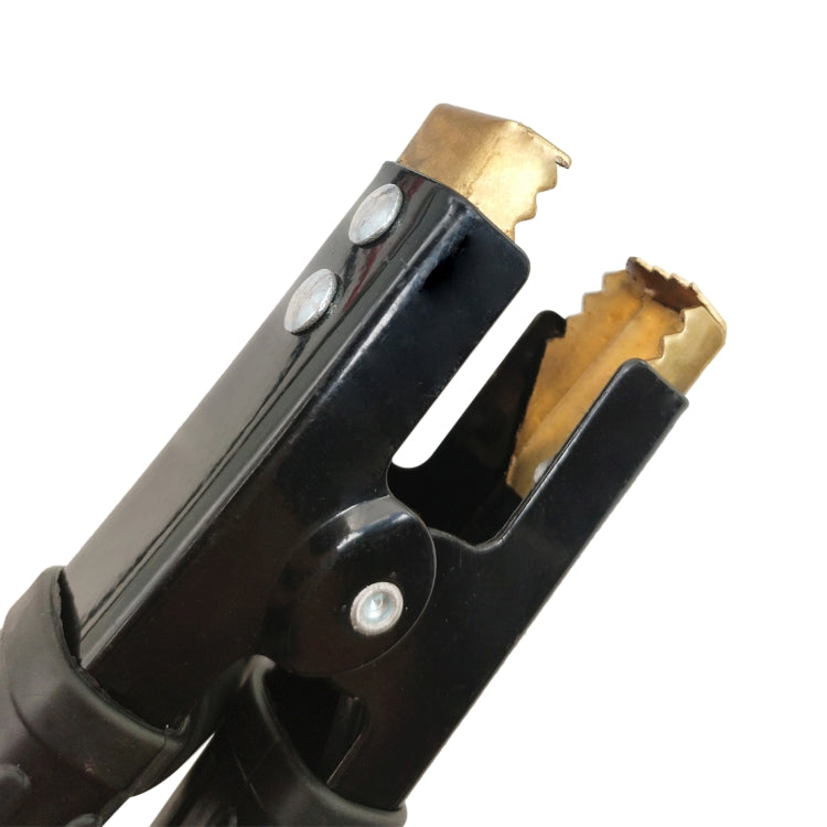 Close-up of black cable clamp and brass battery contact prongs for car zap protector