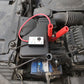 Zap protector module plugged into car engine bay wiring with red and black leads attached