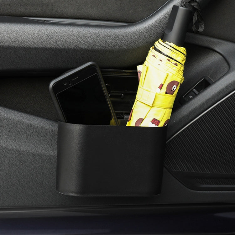 Car trash can bin filled with items including an umbrella and phone inside