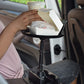 Black car cup holder on seat console with hand placing tissues on tray