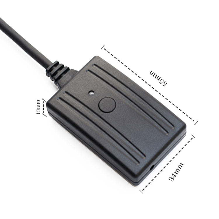 Black multimedia audio cable interface module with circular button and cable attached
