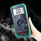 Green automotive digital multimeter tester held in hand with LCD reading 000.1