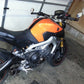 Motorcycle with round reflective rearview mirror on handlebar in garage