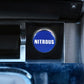 Blue NITROUS metal dust cover installed on a cigarette lighter opening