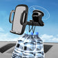 Car dashboard phone holder with black cradle and circular suction base, holding a phone