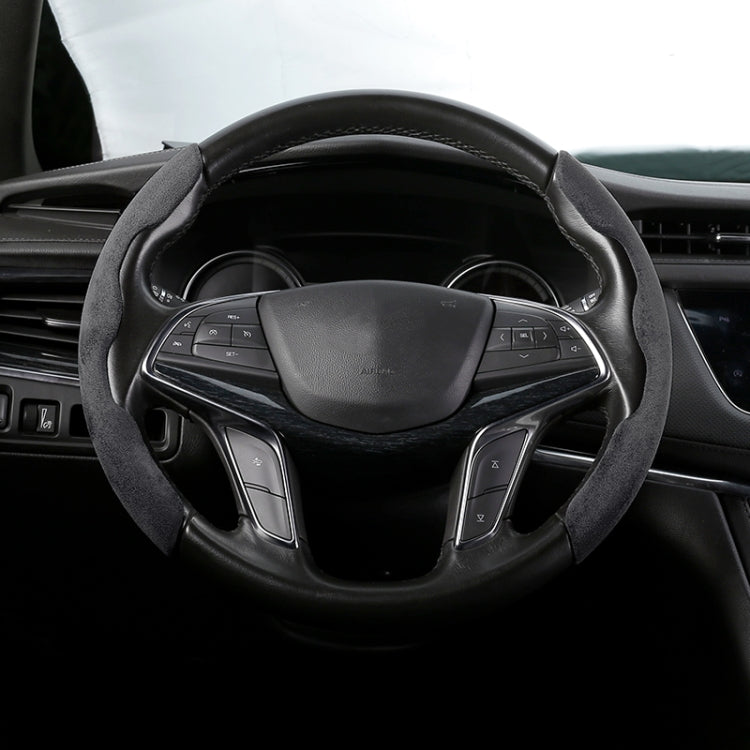 Black suede steering wheel cover, front view on a car wheel