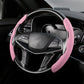 Pink suede universal steering wheel cover fitted on a car’s wheel